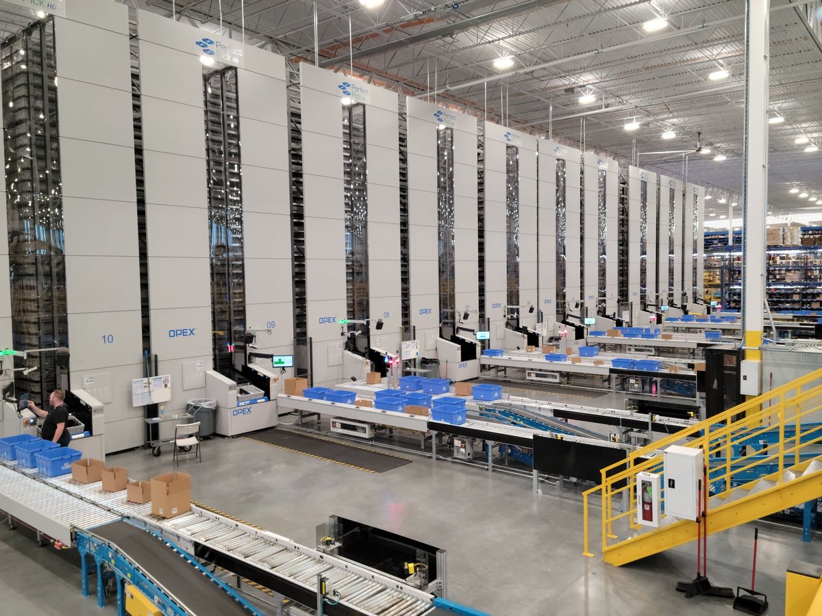 Goods-to-person units serving picking stations, part of a warehouse robotics integration