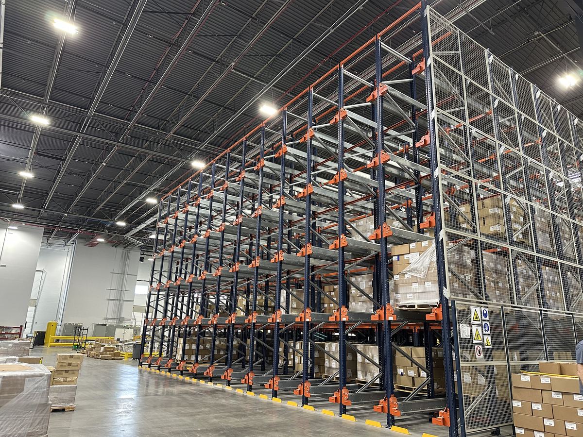 Deep-lane pallet rack served by a pallet shuttle system in a distribution center